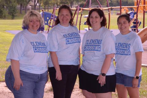 Photo of 4 Fifth Grade staff near the playground.