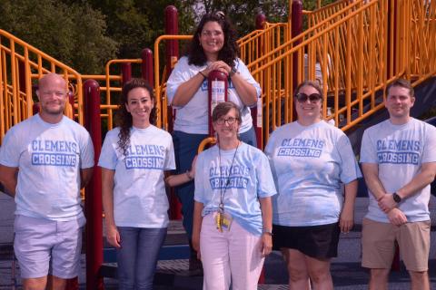 Photo of 6 Related Arts staff posing on the playground.