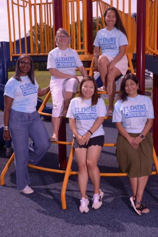 Photo of 4 Academic Support staff and 1 Counselor posing on the playground.