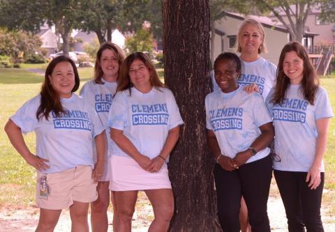 Photo of 6 Second Grade staff under a tree.