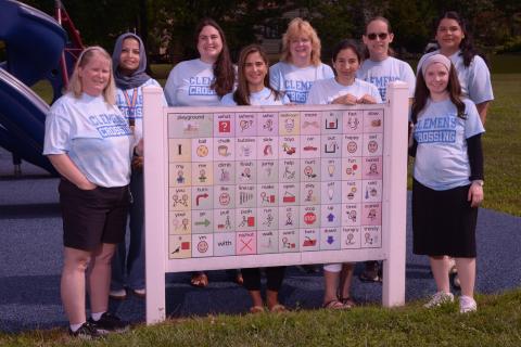 Photo of 9 Special Education staff posing on the playground.